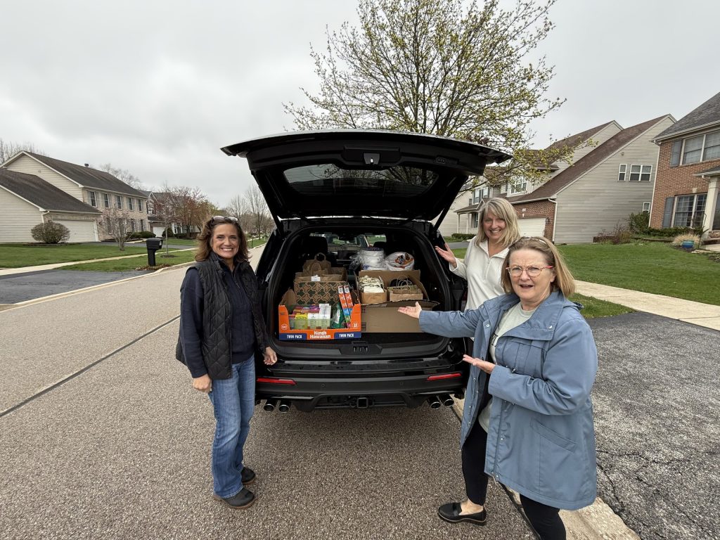btd volunteers showing off a full carload of donations